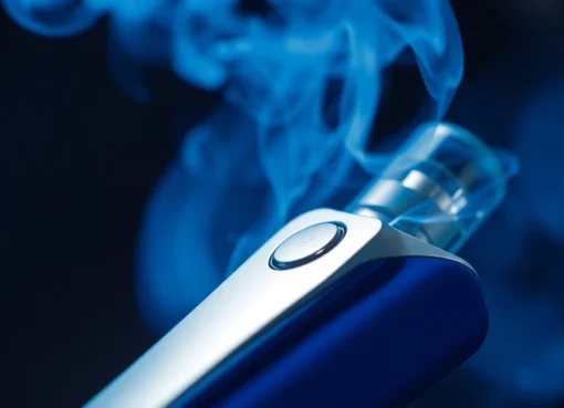 Modern e-cigarette device emitting vapor, showcasing sleek design and vapor clouds for vaping